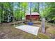 Backyard with a playground, slide, and swingset surrounded by lush green trees at 800 Knox Ln, Canton, GA 30114