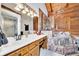 Unique bathroom featuring a marble-tiled tub, glass shower, and wood paneling at 800 Knox Ln, Canton, GA 30114