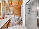 Unique bathroom with marble-tiled tub, glass shower, and log cabin-style wood paneling at 800 Knox Ln, Canton, GA 30114