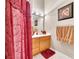 Bathroom featuring warm decor, a wood vanity, and a red shower curtain at 800 Knox Ln, Canton, GA 30114