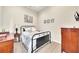 Comfortable bedroom with carpeted floors, a metal bed frame, and neutral decor at 800 Knox Ln, Canton, GA 30114