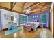 Stylish bedroom with hardwood floors, large windows, and purple accent wall at 800 Knox Ln, Canton, GA 30114