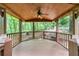 Wooden covered dock with a ceiling fan and view of the surrounding lush forest at 800 Knox Ln, Canton, GA 30114