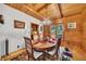 Cozy dining room featuring wood walls, wood flooring, a wooden table, and a unique chandelier at 800 Knox Ln, Canton, GA 30114