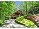 Beautiful exterior view of a cabin-style home with a stone retaining wall and driveway at 800 Knox Ln, Canton, GA 30114