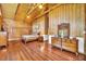 Spacious log cabin main bedroom features wood floors, vaulted ceiling, and rustic wood furnishings at 800 Knox Ln, Canton, GA 30114