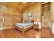 Charming log cabin main bedroom boasts hardwood floors, vaulted ceiling, and rustic decor at 800 Knox Ln, Canton, GA 30114