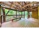 Spacious covered porch overlooking a serene, tree-lined pond, perfect for relaxing at 800 Knox Ln, Canton, GA 30114