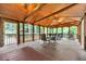 Expansive screened porch includes dining and lounge areas, perfect for entertaining or relaxing at 800 Knox Ln, Canton, GA 30114