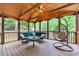 Cozy screened-in porch featuring a comfortable seating area and a unique hanging chair at 800 Knox Ln, Canton, GA 30114