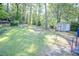 Large backyard with a shed, storage, mature trees, and ample green space at 145 Holly Nw Rd, Atlanta, GA 30314