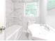 Updated bathroom featuring marble wall tiles, new fixtures, and natural light at 145 Holly Nw Rd, Atlanta, GA 30314