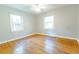 Bedroom with hardwood floors, two windows, and a ceiling fan at 145 Holly Nw Rd, Atlanta, GA 30314