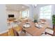 Dining area view showcasing table set, natural light and openness to the adjacent living room at 145 Holly Nw Rd, Atlanta, GA 30314
