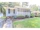 Charming home with a well-maintained lawn, a screened-in porch, and stone walkway at 145 Holly Nw Rd, Atlanta, GA 30314