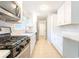 Modern kitchen features white cabinetry and updated appliances for a sleek design at 145 Holly Nw Rd, Atlanta, GA 30314