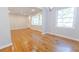 Bright living room features hardwood floors, a ceiling fan, and ample natural light at 145 Holly Nw Rd, Atlanta, GA 30314