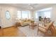 Bright living room features a ceiling fan, hardwood floors, and a seamless transition to the dining area at 145 Holly Nw Rd, Atlanta, GA 30314
