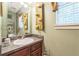 Bathroom vanity with gray counter, decorative lighting, and neutral wall color at 2130 Boulder Gate Dr, Ellenwood, GA 30294