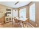 Dining area with natural light, tiled floor and light-colored wooden table and chairs at 2130 Boulder Gate Dr, Ellenwood, GA 30294