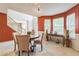 Bright dining room showcases warm walls, a round table and an inviting view to the home's foyer at 2130 Boulder Gate Dr, Ellenwood, GA 30294