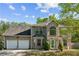 Charming two-story brick home with a well-manicured lawn, two-car garage, and beautiful, arched entryway at 2130 Boulder Gate Dr, Ellenwood, GA 30294
