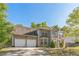 Lovely two-story brick home with two-car garage framed by mature trees, offering curb appeal at 2130 Boulder Gate Dr, Ellenwood, GA 30294