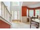 Inviting foyer with an open staircase, hardwood floors, and large windows, offering a warm welcome at 2130 Boulder Gate Dr, Ellenwood, GA 30294