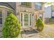 Close up of the entry to a brick home showing a well kept lawn and manicured greenery at 2130 Boulder Gate Dr, Ellenwood, GA 30294