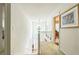 A hallway featuring carpet floors, white walls, a staircase, and a chandelier at 2130 Boulder Gate Dr, Ellenwood, GA 30294