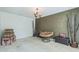 Spacious living room with neutral carpet and an accent wall. Cozy Papasan chair for relaxed living at 2130 Boulder Gate Dr, Ellenwood, GA 30294