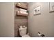 Stylish powder room features floating shelves with decorative accents and modern fixtures at 505 Bainbridge Dr, Atlanta, GA 30327