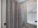 Well-lit bathroom with a patterned shower curtain and a window with blinds at 505 Bainbridge Dr, Atlanta, GA 30327