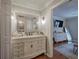 Elegant bathroom vanity with a large, decorative mirror and stylish lighting fixtures at 505 Bainbridge Dr, Atlanta, GA 30327