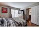 Comfortable bedroom featuring a striped bedspread, large window and an entertainment area at 505 Bainbridge Dr, Atlanta, GA 30327