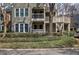 Exterior view of condo with landscaping, showing the decks and stairs at 505 Bainbridge Dr, Atlanta, GA 30327