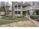 Townhouse exterior with dual-level decks, green siding, and landscaping at 505 Bainbridge Dr, Atlanta, GA 30327
