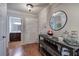 Inviting hallway with hardwood floors and decorative console table leading to the bathroom at 505 Bainbridge Dr, Atlanta, GA 30327