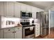 Bright kitchen features stainless steel appliances, white cabinets and stone countertops at 505 Bainbridge Dr, Atlanta, GA 30327