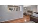 Cozy living room area featuring an open view into the bright kitchen and a dining area with hardwood floors at 505 Bainbridge Dr, Atlanta, GA 30327
