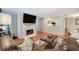 Bright living room with hardwood floors, a large TV over the fireplace and a view into the modern kitchen at 505 Bainbridge Dr, Atlanta, GA 30327