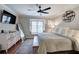 Bright bedroom featuring a large window seat, hardwood floors, and a sleek modern dresser at 505 Bainbridge Dr, Atlanta, GA 30327
