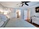 Comfortable bedroom with a ceiling fan, hardwood floors, and an en suite bathroom with a walk-in closet at 505 Bainbridge Dr, Atlanta, GA 30327