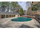 Outdoor pool closed for season, surrounded by trees and lounge area at 505 Bainbridge Dr, Atlanta, GA 30327