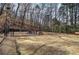 Tennis court surrounded by trees with benches at 505 Bainbridge Dr, Atlanta, GA 30327