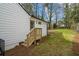 Backyard with wood steps leading to the lawn and surrounding trees at 1111 Edgefield Sw Dr, Atlanta, GA 30310
