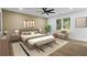 Comfortable bedroom featuring a ceiling fan, wood flooring, a bench, and a chair by the window at 1111 Edgefield Sw Dr, Atlanta, GA 30310
