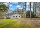 Rear exterior view displays the home's updated siding, windows, and expansive lawn at 1111 Edgefield Sw Dr, Atlanta, GA 30310