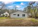 Rear exterior view displays the home's updated siding, windows, and manicured lawn at 1111 Edgefield Sw Dr, Atlanta, GA 30310