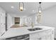 Open-concept kitchen with stone countertops, and an island featuring a stainless steel sink at 1111 Edgefield Sw Dr, Atlanta, GA 30310